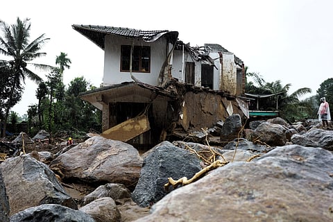 A rescuer stands next to a damaged houses on the 2nd day of operation following landslide in Wayanad district, Kerala, Wednesday, July 31, 2024.